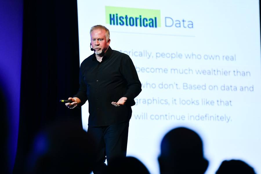 A speaker presenting homebuyer research data on a main stage