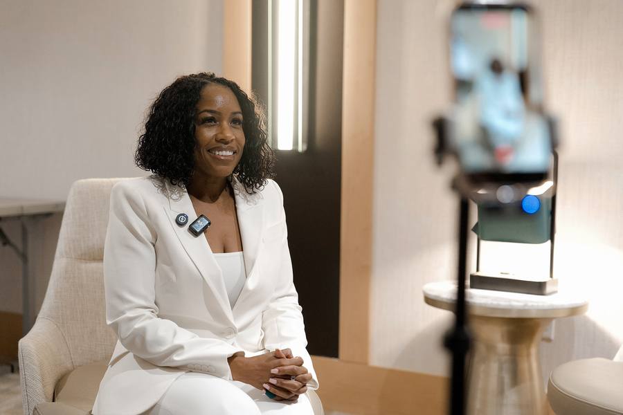 An Ambassador recording free education content on camera